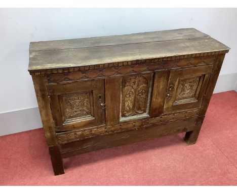 A XVII Century and Later Oak Cabinet on Stand, with carved frieze, central panel, twin panelled cupboard doors on a later bas