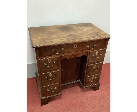 A Mid XVIII Century Mahogany Kneehole Desk, with single drawer over a secret drawer, flanking sides with three small drawers,