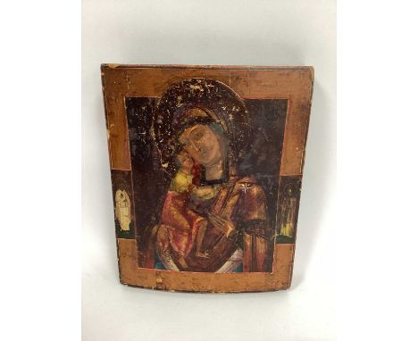 An Icon, painted with the Madonna and Child flanked at both sides by a Saint, on panel, 27 x 22cm.