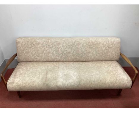 Greaves &amp; Thomas; A Mid XX Century Teak Sofa Bed, upholstered in a beige floral fabric, 200cm wide.