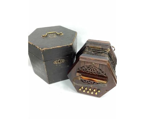 An Early XX Century Rosewood Concertina, with twenty buttons (some missing) with fretwork ends, leather straps, original box.