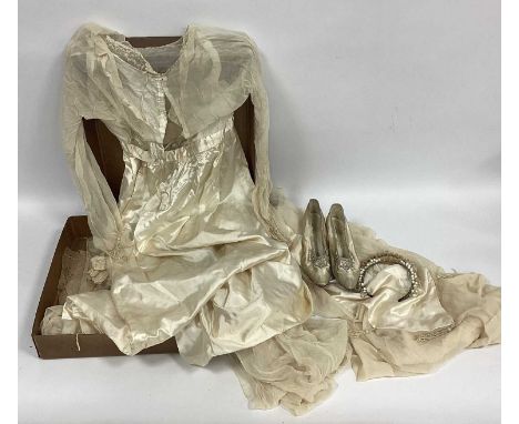 An Early XX Century Cream Satin and Silk Chiffon Wedding Dress, (very fragile and some pieces detached), with beadwork tassel