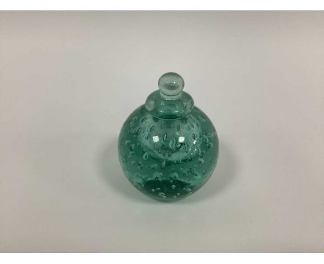 A Late XIX Century Green Glass Dump Inkwell and Cover, with teardrop inclusions, 11.5cm high.Base with two chips, stopper wit