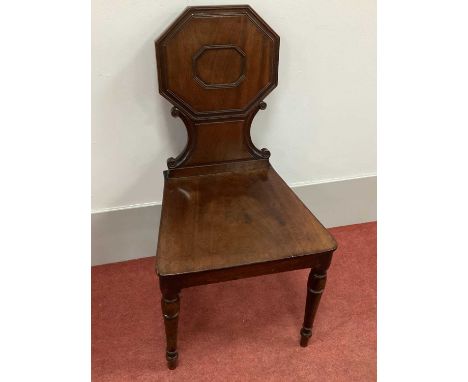 An Early XIX Century Regency Mahogany Hall Chair, with octagonal panelled back, 'C' scrolls, and solid seat on turned forefro