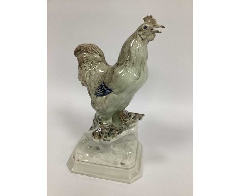 A c.1930's Losol Ware Model of a Cockerel, in lustre glaze, impressed H.P. Miller, on shaped square base, 42cm high.