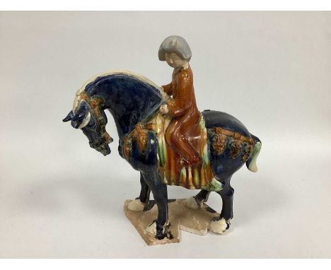 A Tang Style Horse and Rider, of typical form with saddle in streaked glazes, shaped base, 46cm high.