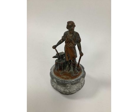 A Vulcan Radiator Mascot, in the form of a blacksmith with his tools, 17cm high.