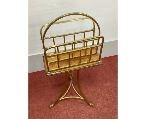 An Early XX Century Brass and Oak Magazine Rack, on swept legs united by stretchers, 88cm high, 36cm wide.