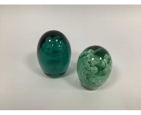 Two Late XIX Century Green Glass Dump Paperweights, with flowerhead inclusions, 12cm and 14cm high. (2)Lighter coloured examp