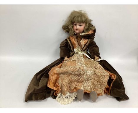 An Armand Marseilles Bisque Headed Large Doll, with painted features, open mouth and fixed eyes, jointed body, later clothing