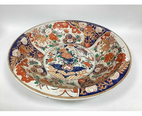 A Modern Chinese Pottery Dish, decorated in the Imari palette with panels of flowers, dogs of fo and butterflies, character m