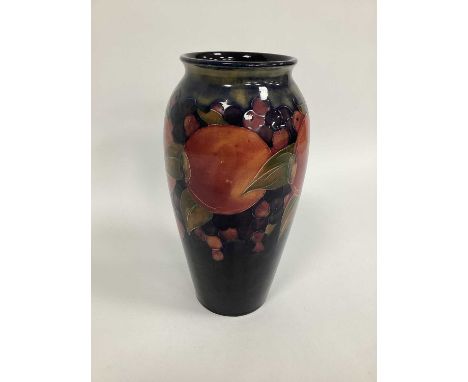 A Moorcroft Pottery Vase, of ovoid form, painted in the 'Pomegranate' pattern against a dark blue ground, impressed marks, si