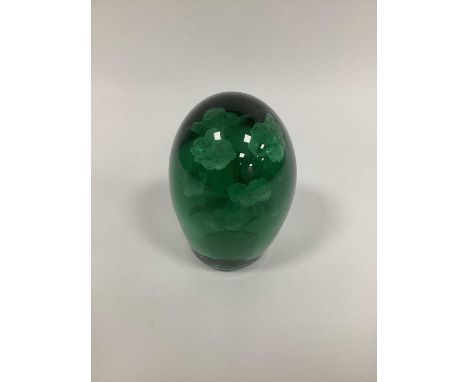 A Large Late XIX Century Green Glass Dump Paperweight, with flowerhead inclusions, 16cm high.Base rough and with chips, small