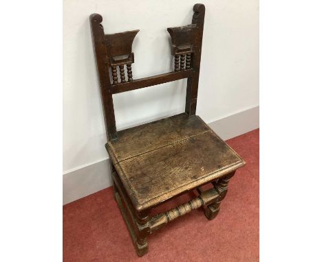 A XVII Century Joined Oak Chair, with rail support, bobbin turning and solid seat on turned and block forefront legs united b