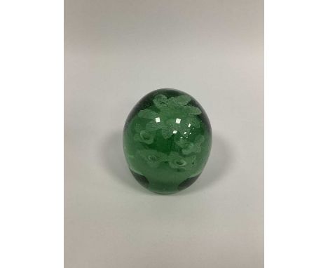 A Late XIX Century Green Glass Dump Paperweight, with flowerhead inclusions, 12cm high.Some surface scratching.