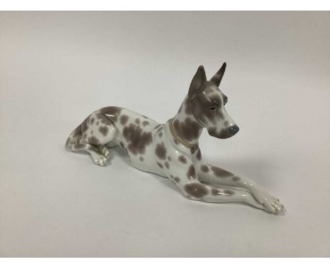 A Lladro Porcelain Model of Seated Great Dane with Collar, model number 1068, printed marks, 30cm long (chip to ear and repai