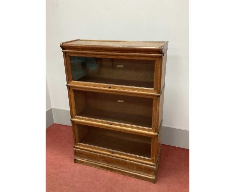 An Early XX Century Oak Globe Wernicke Three Tier Bookcase, with glass sliding doors, on shaped base, 125cm high, 86.5cm wide