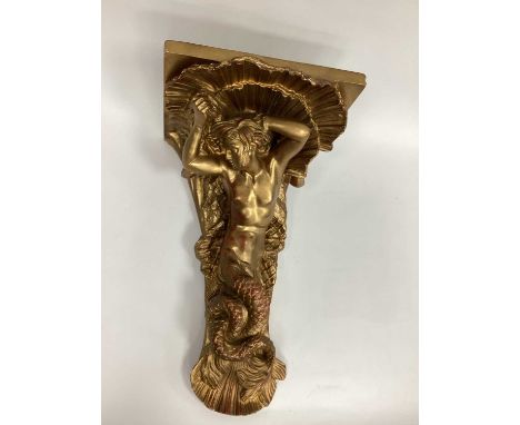 A Large Plaster Gilded Wall Bracket, in the form of a mermaid below a shell, 54cm tall.not wood, plaster, 32cm at widest poin