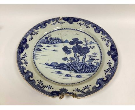 A Chinese Porcelain XIX Century Large Circular Charger, painted in blue with a Chinoiserie river landscape, 55cm diameter. (A