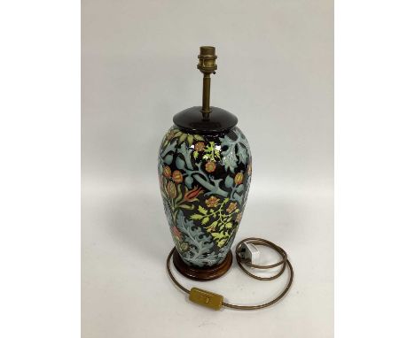 A Moorcroft Pottery Table Lamp, painted in the 'Autumn Flowers' pattern, of baluster form with a wooden base, 34cm high.