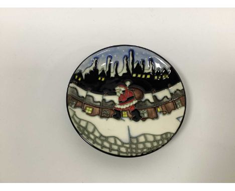 A Moorcroft Pottery Circular Pin Tray, painted in 'The Pots' design by Vicky Lovatt, with Santa Claus and his sack of toys on