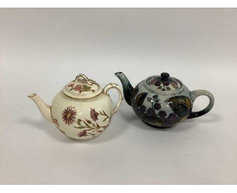 A Moorcroft Pottery teapot and Cover, of globular form painted in the 'Bramble' pattern against a blue ground, impressed mark