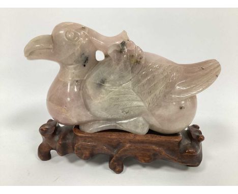 A Chinese Carved Rose Quartz Figure of a Bird, 19cm long on a hardwood stand.