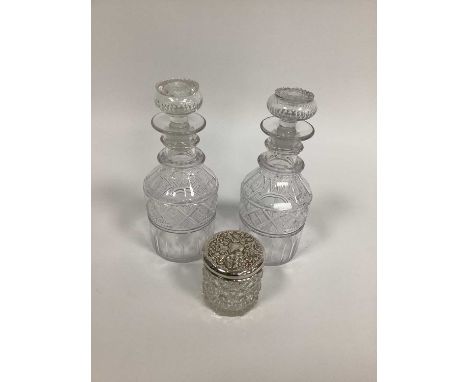 A Pair of Georgian Glass Decanters and Stoppers, the part fluted bodies with cut bands, the necks with two ring bands, 21cm h