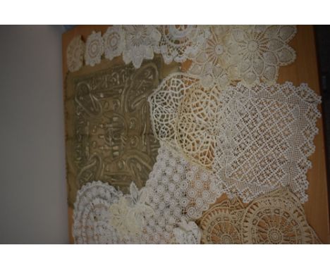 A variety of antique and vintage hand worked mats and similar.