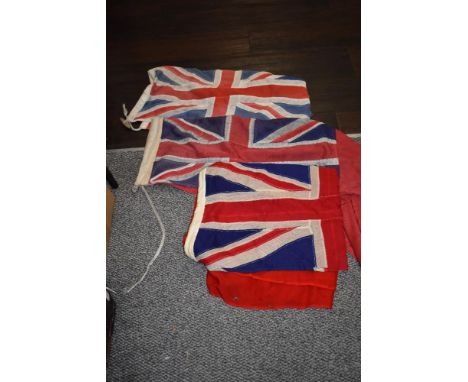 Three vintage red Ensign flags, of different sizes
54cm x 24cm, 48cm x 25cm, 33cm x 70cm.
Partial moth to the largest flag.&n