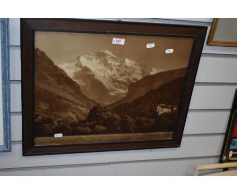 A sepia tone photographic print of an Alpine mountain view, displayed in a 20th Century oak frame, 44cm x 55cm overall