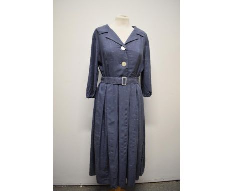 A 1950s slate blue dress with white fleck running throughout, shawl collar, buttons to front, matching belt, side metal zip a