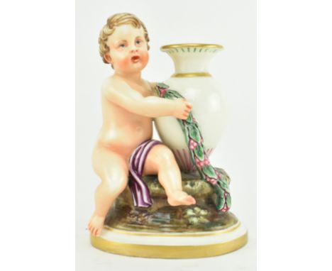 A mid 19th century c1860 Worcester Kerr & Binn porcelain Cherub with amphora figurine. Comprising of a child sat on a rock ho