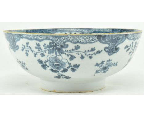 An English believed 18th century hand painted blue & white Delft ceramic bowl. The bowl having floral swags along the inner r