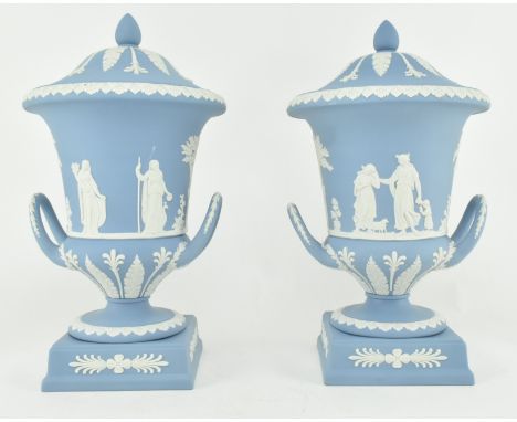 A pair of Wedgwood jasperware ceramic light blue twin handled campagna urns vases with lids. Each vase having a domed cover w