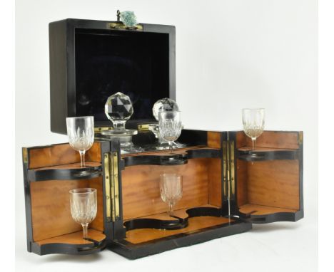A 19th century Victorian coromandel and brass mounted decanter box. The hinged lid and front opens to reveal a fitted interio