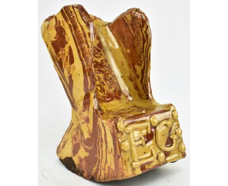 A Victorian 19th century circa 1880s Agate-ware ceramic model of a wingback rocking chair. The chair marked with initials EG 