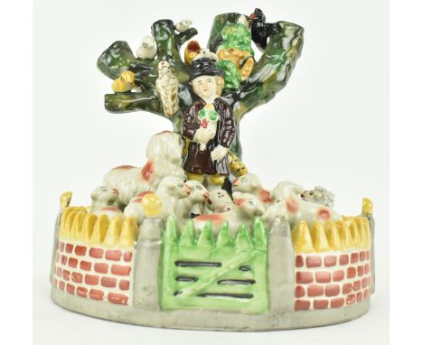 A large pearlware pottery ceramic display spill vase in the style of Staffordshire pottery. The vase modelled as a shepherd w