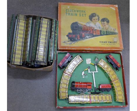 A Chad Valley clockwork train set and a box of train track 