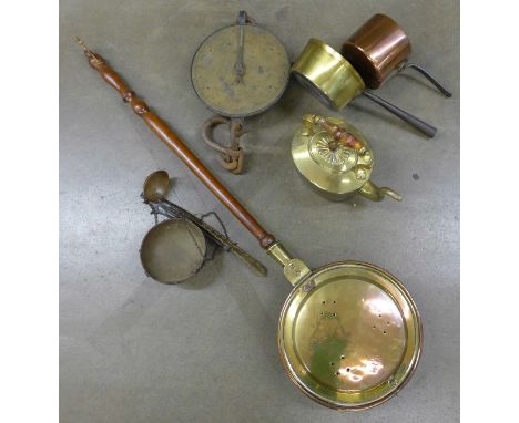 Brass and copper saucepans, a ladle, balance scales and spring scales and a Georgian bed warming pan with fruitwood handle **