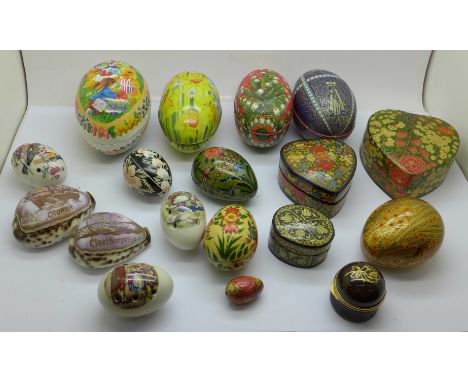 A collection of papier mache trinket boxes, egg shape boxes and carved shells 