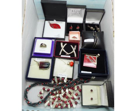 A collection of silver mounted red stone set jewellery, two necklaces, a pair of large silver earrings and a silver bangle 