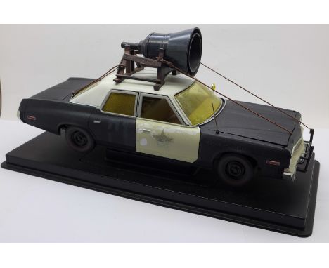 A heavy die-cast model Blues Brothers police car on a plinth, 31cm 