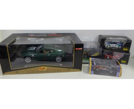 Six model vehicles in boxes, including Maisto, Aston Martin DB7 Vantage and Ixo 