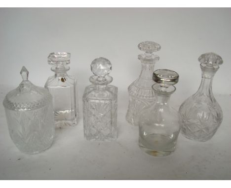 A heavily cut crystal decanter and stopper together with four other decanters etc. 