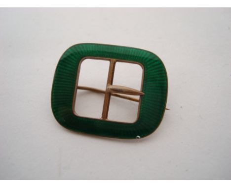 An early 20th Century Continental silver gilt and green guilloche enamel buckle brooch. 