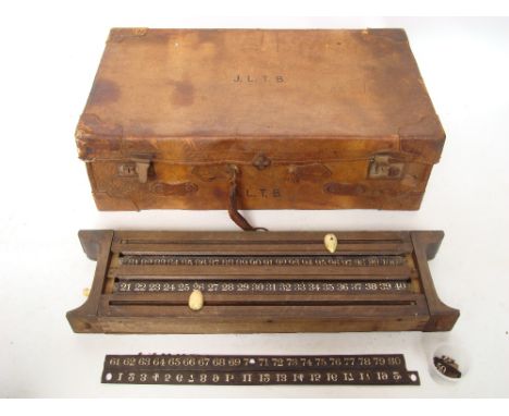 An early 20th Century leather suitcase (handle a/f) and a late Victorian oak billiards roller scoring board, a/f. 