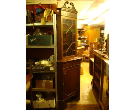 Edwardian mahogany free standing corner cupboard, the upper section with astragal glazed cupboard door and fret cut broken sw