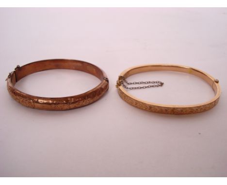 An Edwardian 9 carat rose gold hinged bangle, foliate chased together with another similar Edwardian 9 carat gold hinged bang