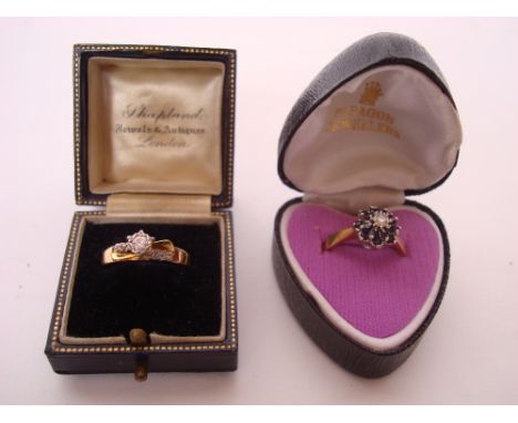 An 18 gold and platinum set diamond solitaire ring, with raised claw set central stone approx 1/4 carat and shoulders set wit